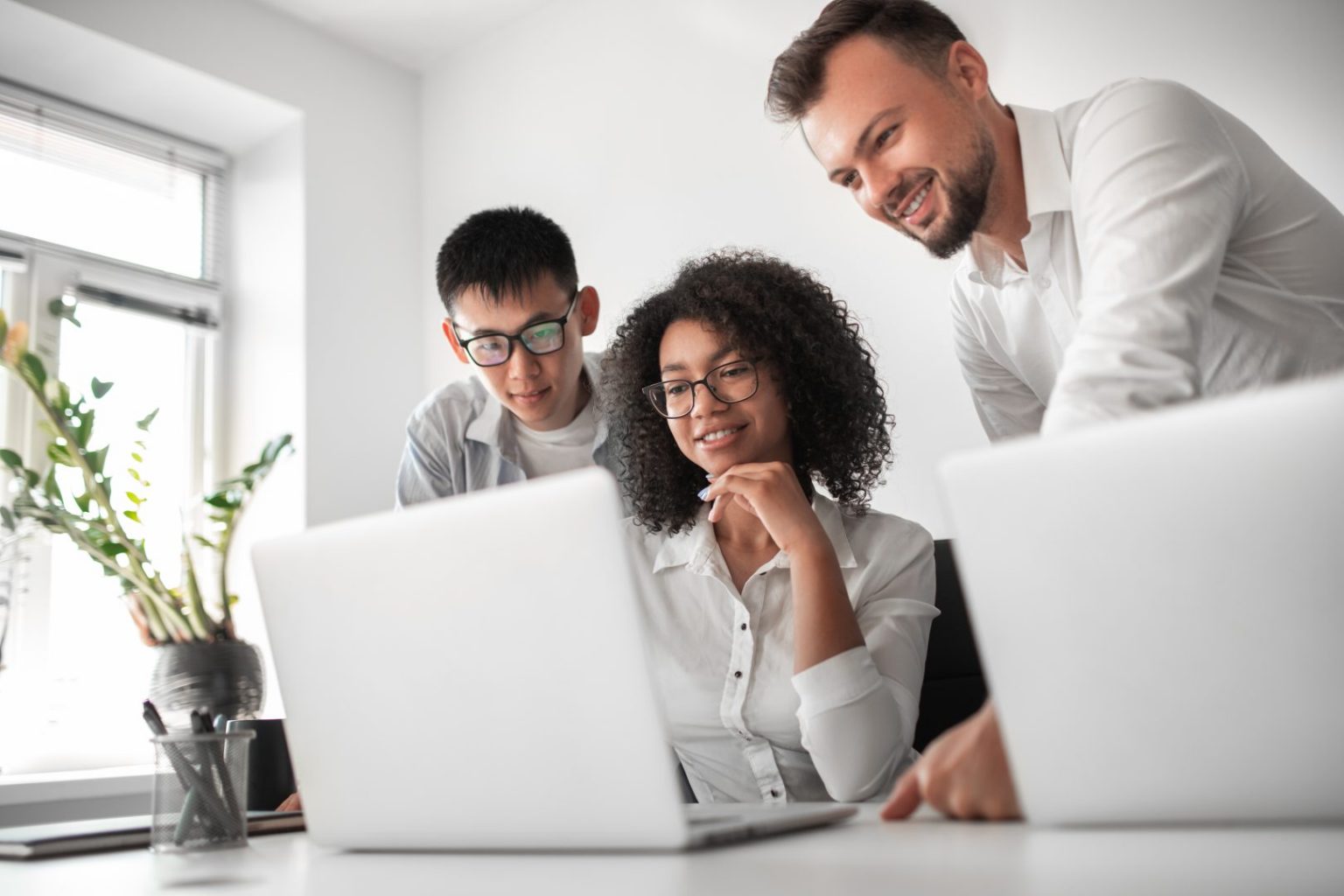 Jovem editor sorrindo para a câmera em sua mesa